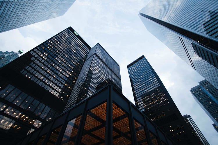 An impressive image of corporate skyscrapers reaching for the sky taken from the ground level.  